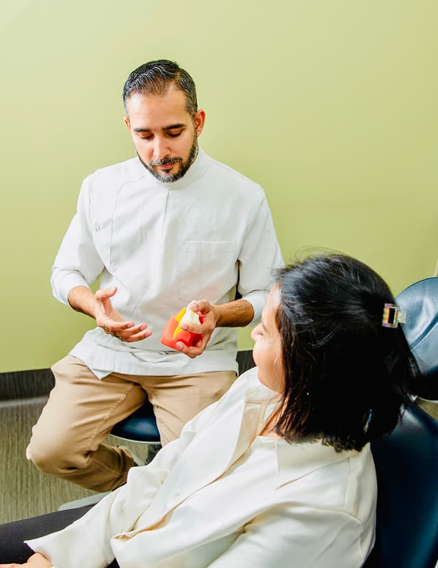 A Dapto dentist explaining dental care to a patient in the clinic.