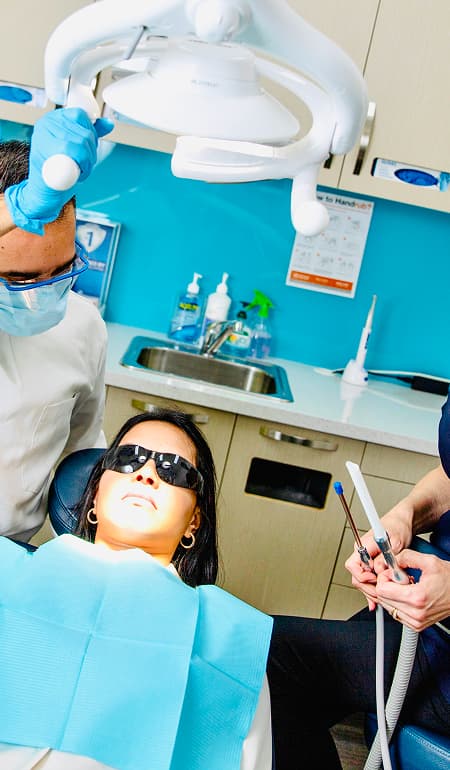 A dentist treating a patient during a general dentistry appointment.